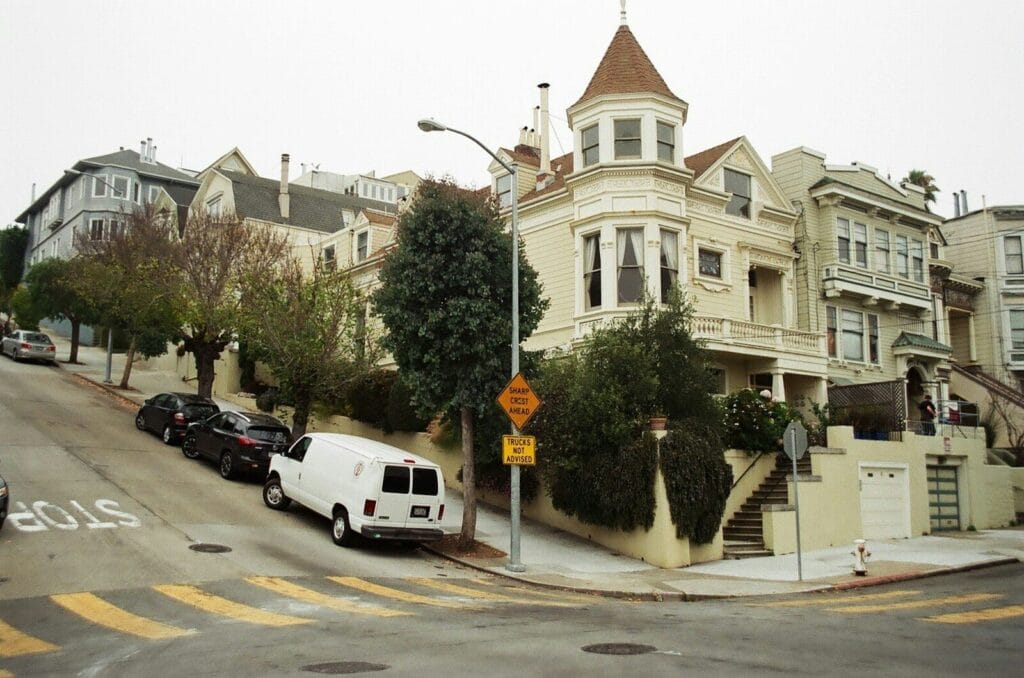 white van parked beside black car near green tree during daytime, san francisco bay area