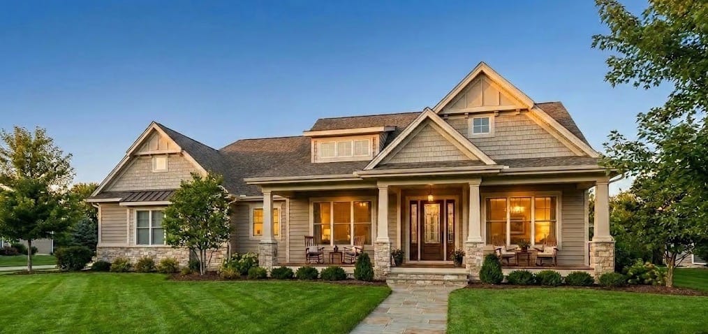 The American Dream. Beautiful luxury home with a large green lawn representing USA houses for sale, new construction, and real estate investment opportunities.