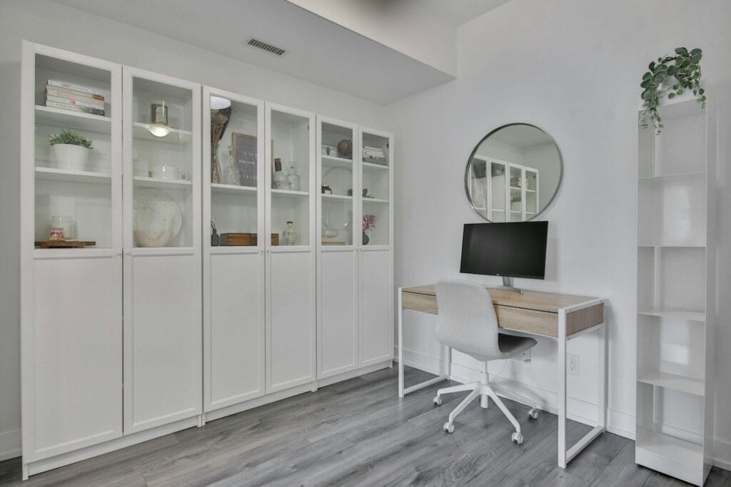 a white room with a desk and a mirror