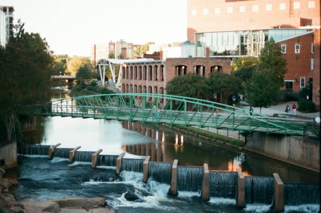 Greenville water falls near green bridge during daytime