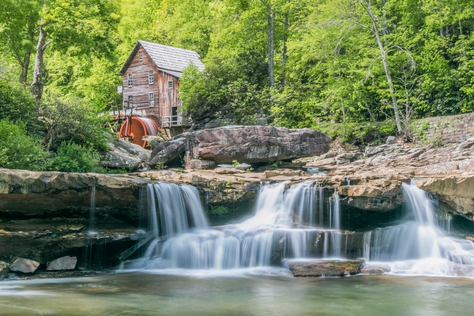 brown waterfalls near house and forest trees during daytime, West Virginia