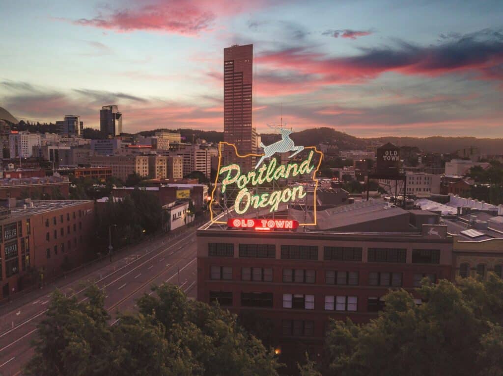 a large neon sign on top of a building in Portland Oregon