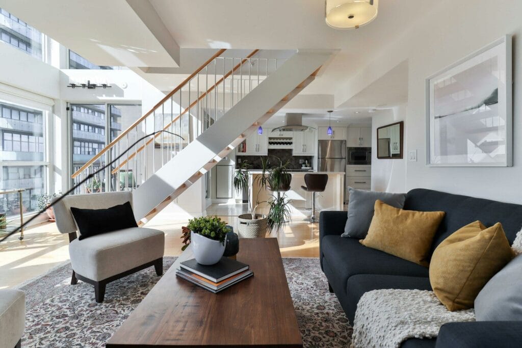 A living room with a staircase, providence real estate.