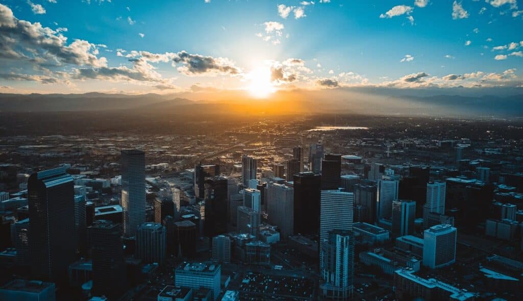 Denver Colorado. View of the sun is setting over a large city