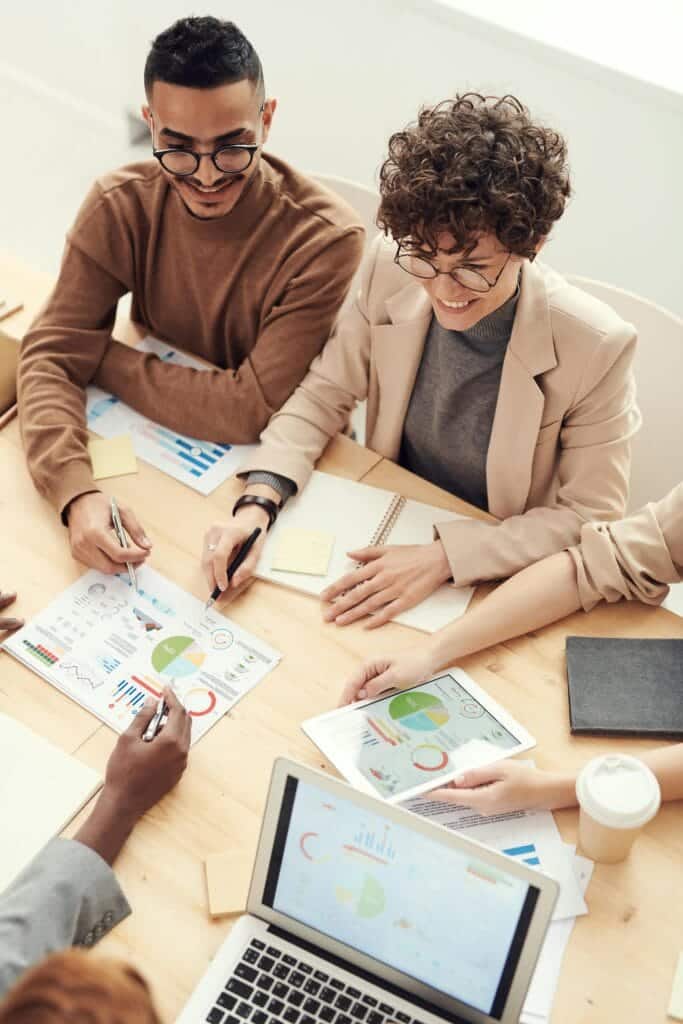 A diverse team of professionals collaborating over charts and graphs during a business meeting. Talking about Florida homes.