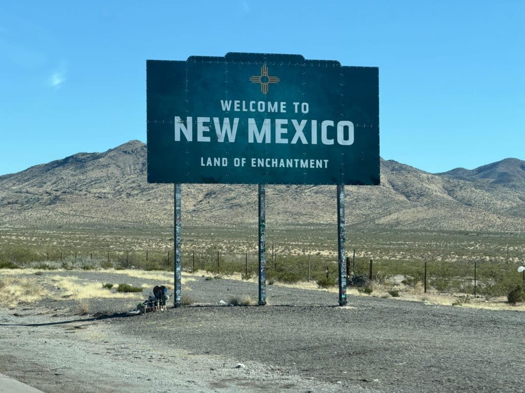 Iconic welcome sign for New Mexico in a desert landscape, tracing the state's enchanting charm.