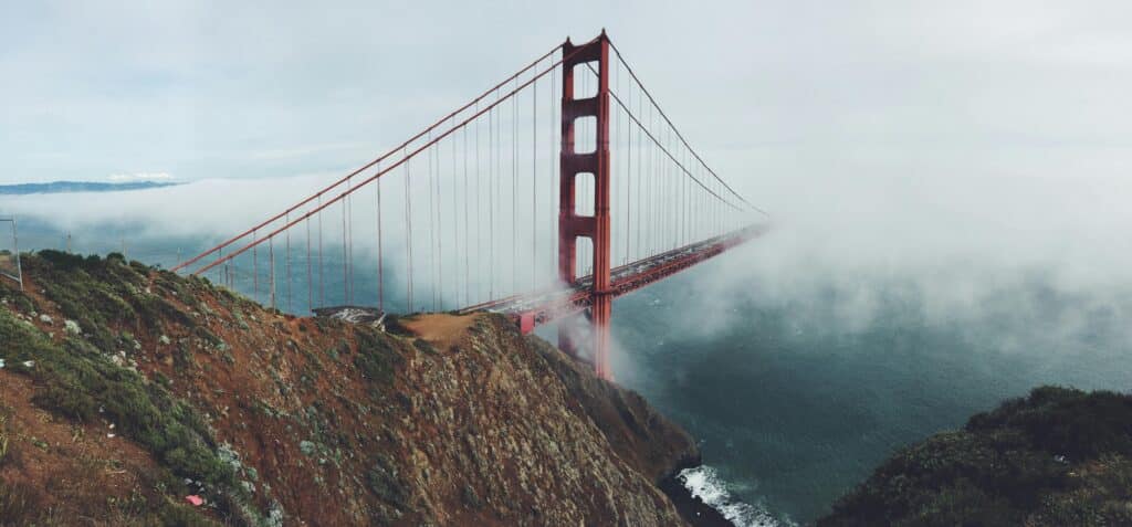 Marin County and San Francisco California. A stunning view of the Golden Gate Bridge partially shrouded in mist, connecting San Francisco's serene landscapes. San Francisco Bay Area