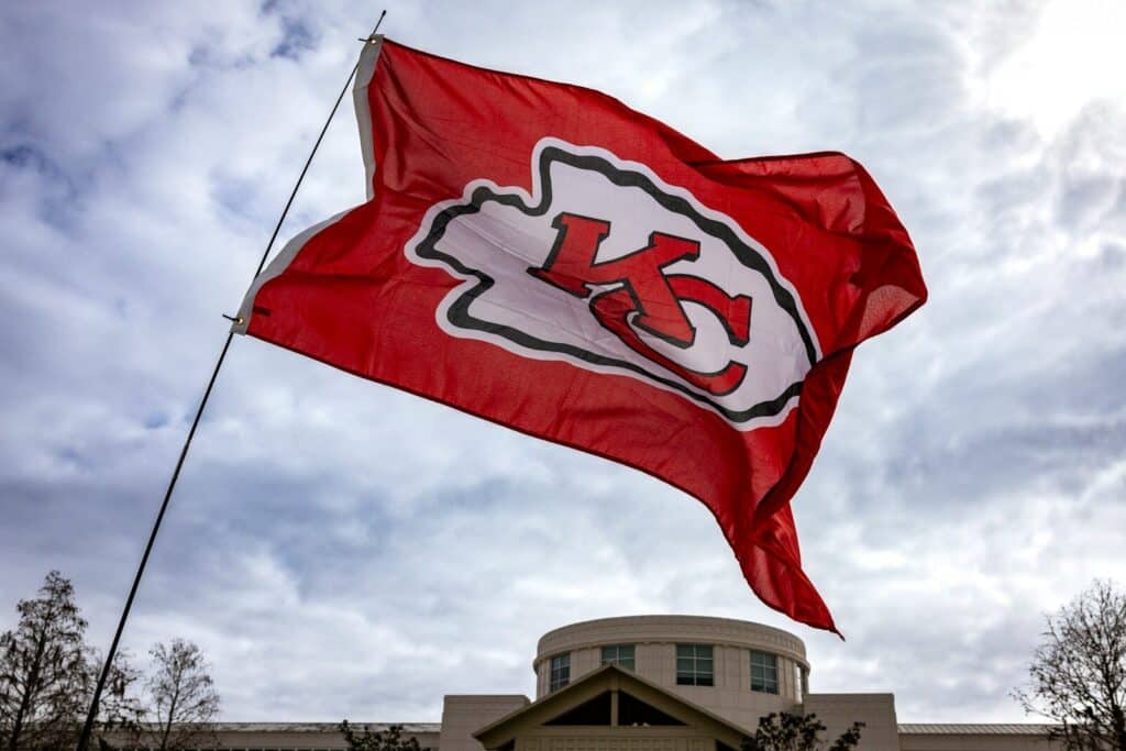 a kansas city chiefs flag flying in front of a building kansas city missouri and kansas city kansas both route for them, kansas city missouri real estate and kansas city kansas real estate, kansas city ks