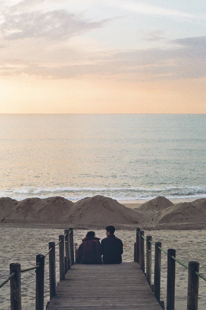 South Carolina is beautiful. A couple enjoys a romantic moment on a pier overlooking the ocean during a beautiful sunset.