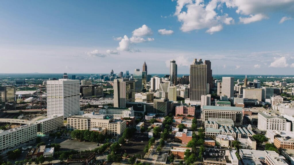 Stunning aerial view of Atlanta's modern skyline under a clear blue sky. Atlanta Real Estate and New Homes for sale.