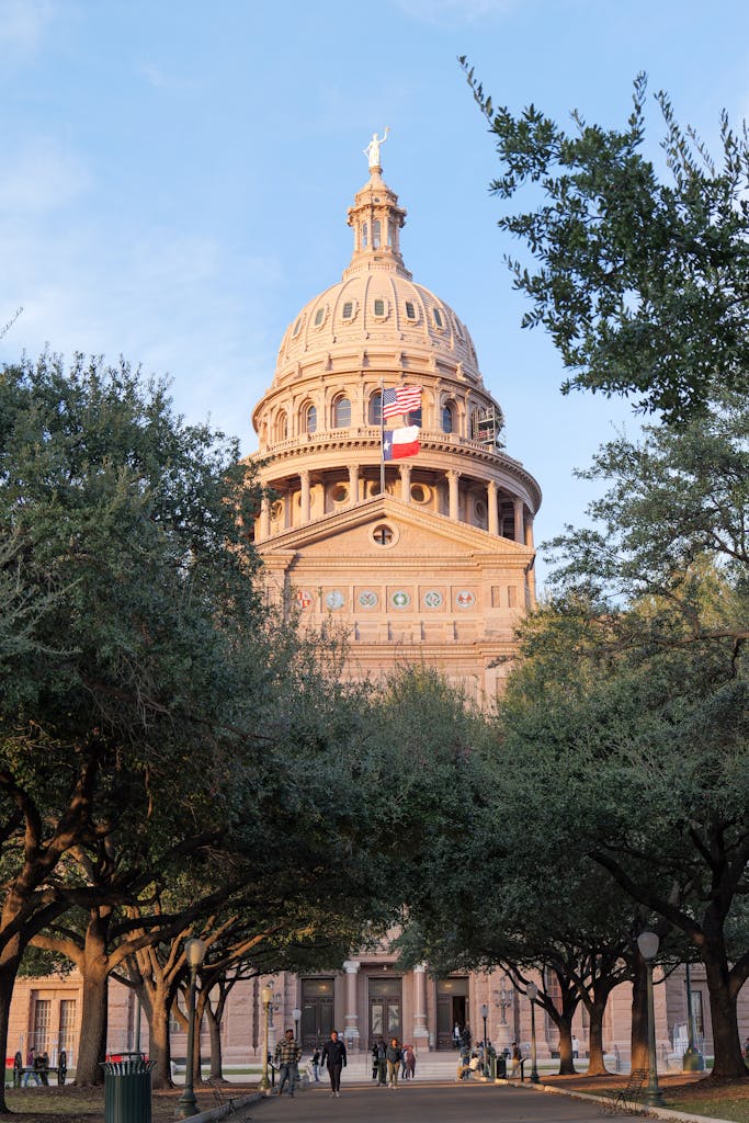 Stunning view of the Texas State Capitol surrounded by trees in Austin, Texas.