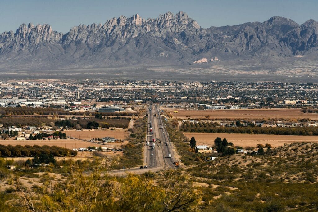 a road showing las cruces real estate with a mountain in the background