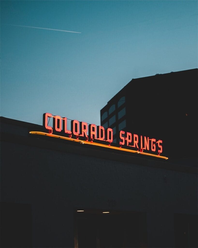 a neon sign on the side of a building in Colorado Springs Colorado